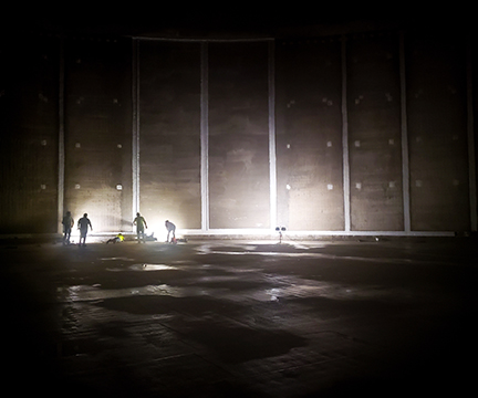 Ixom Watercare Onsite Service Team working inside a dark drinking water tank