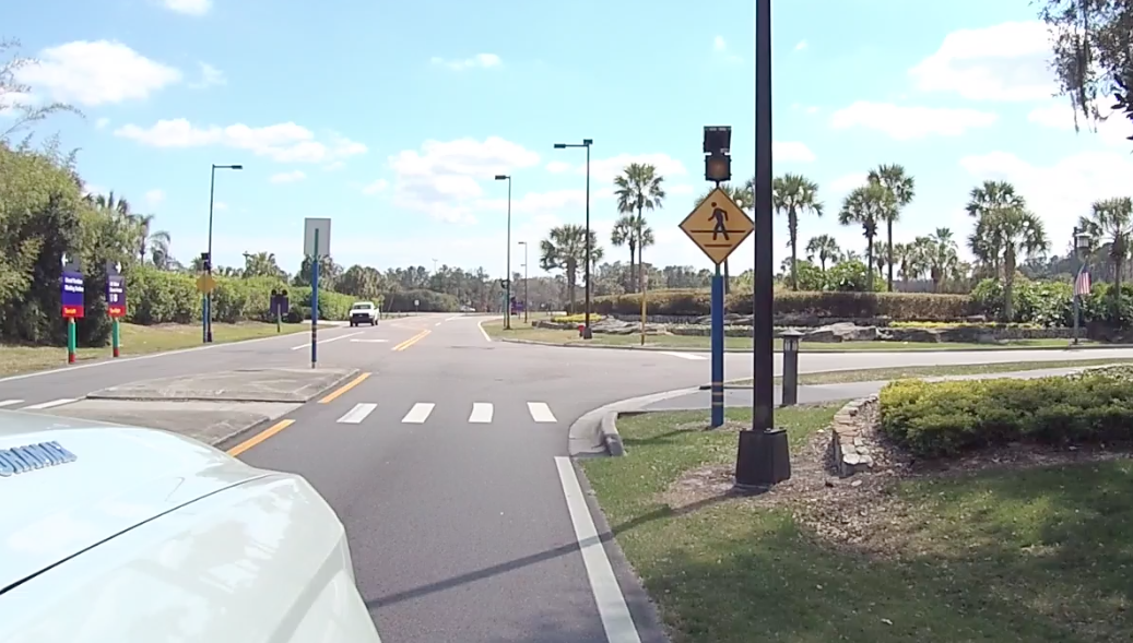vehicle pulling up to an intersection & pedestrian cross walk- distracted driving campaign