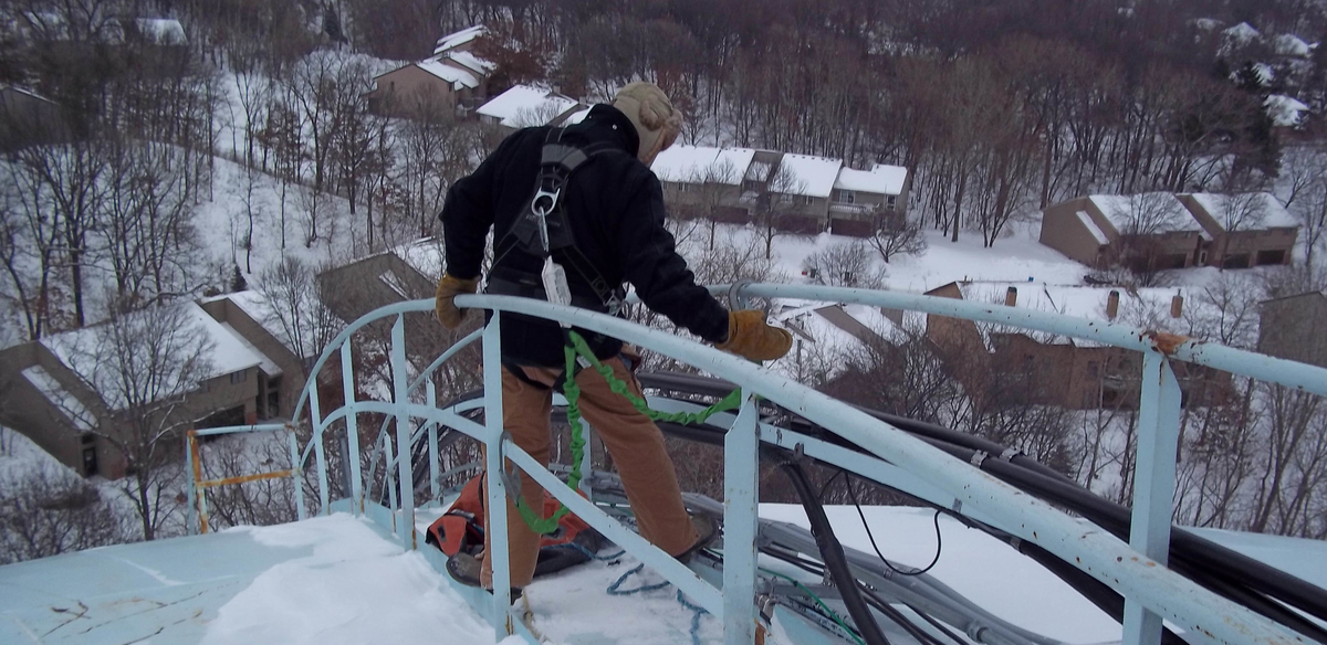 Medora Corporation service crew on snow covered tank while deploying mixer